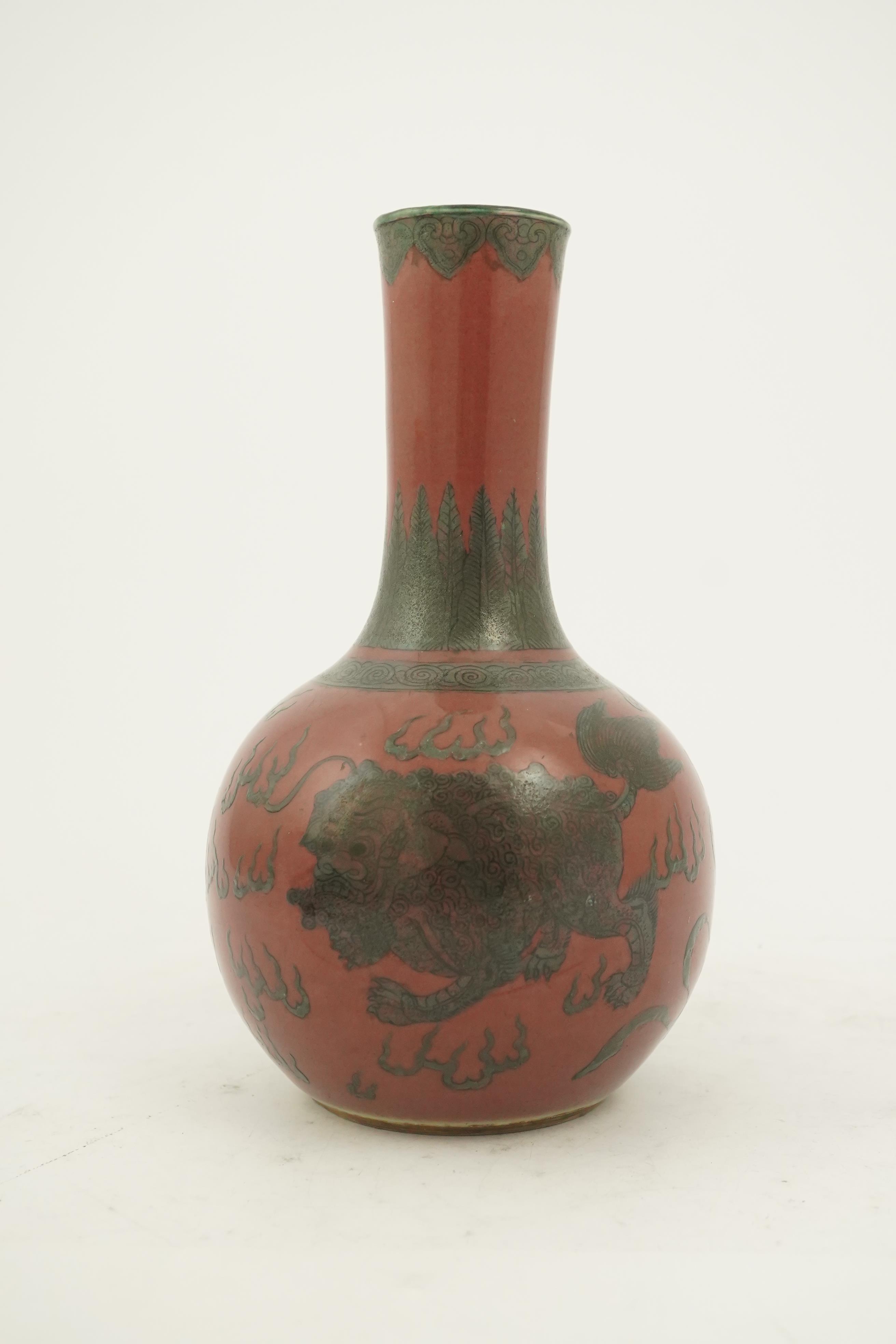 A Chinese green enamelled sang de boeuf ground 'lion' bottle vase, probably 18th century